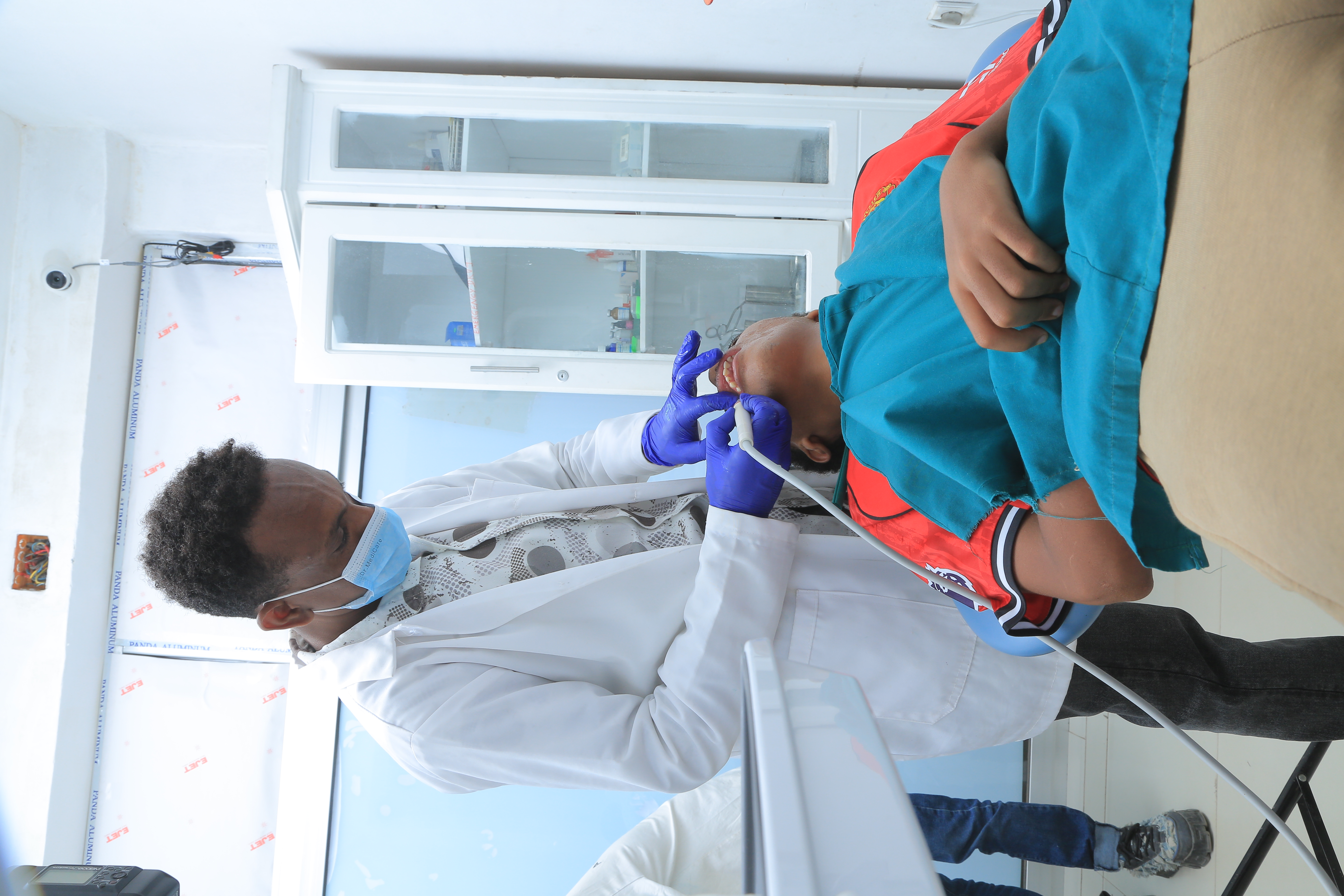 A dentist performing a procedure on a patient.