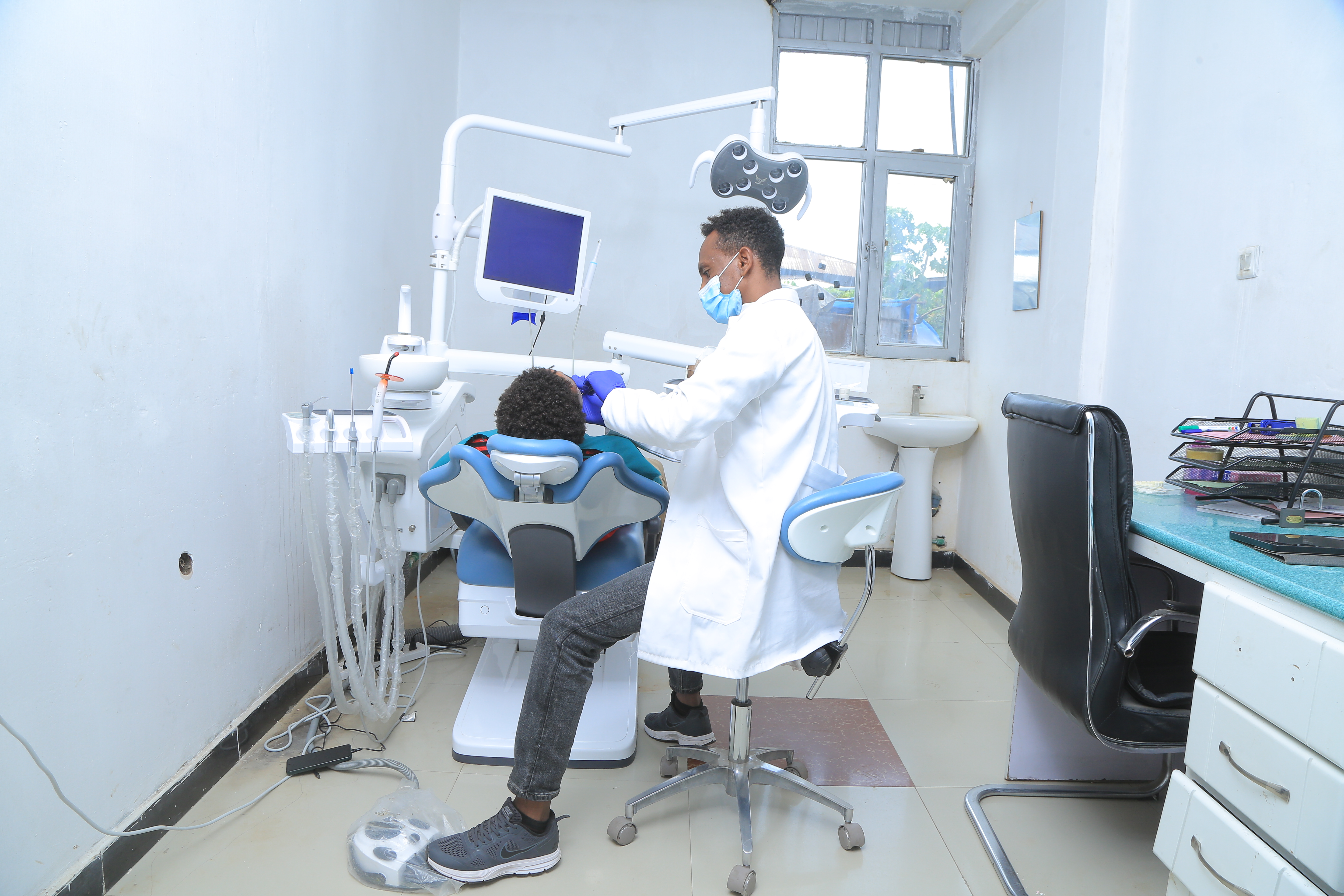 A dentist working on a patient
